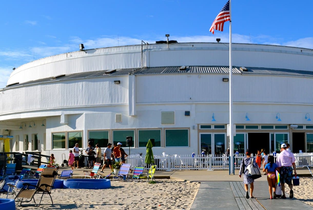 The main clubhouse at The Sands seen from the beach, with the flag and the boardwalk up to the entrance